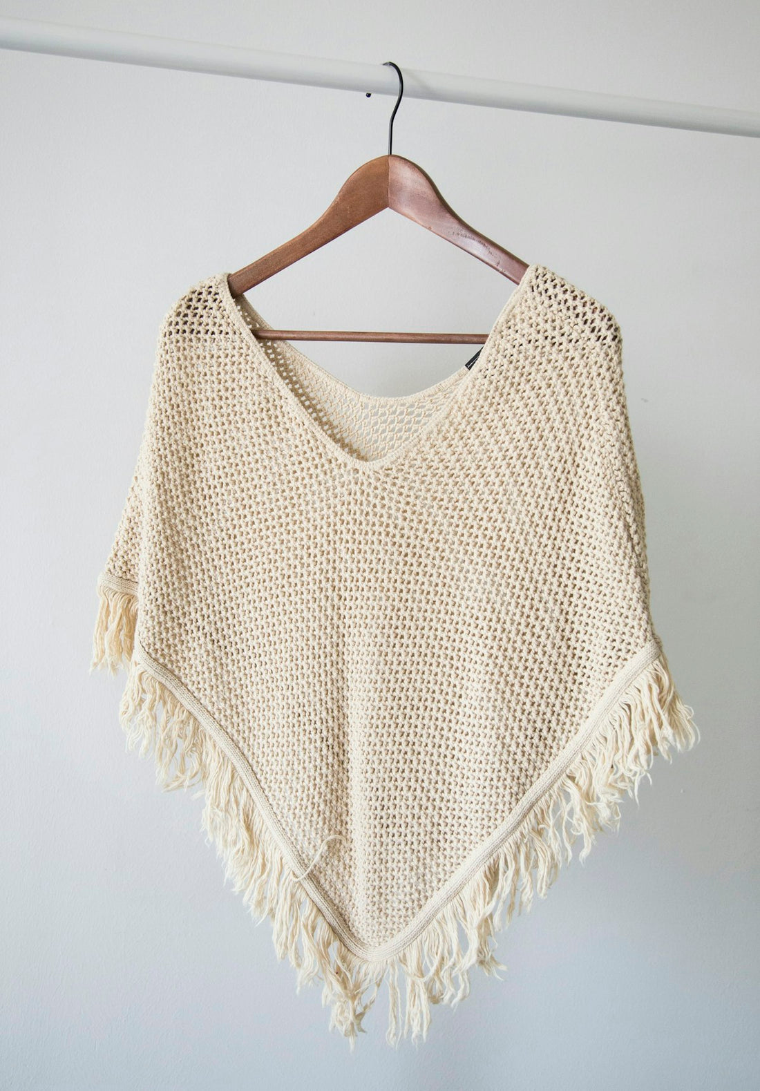 Folded wool jumpers in neutral tones — wool care guide UK