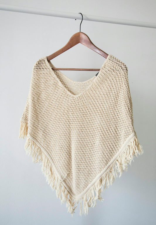 Folded wool jumpers in neutral tones — wool care guide UK